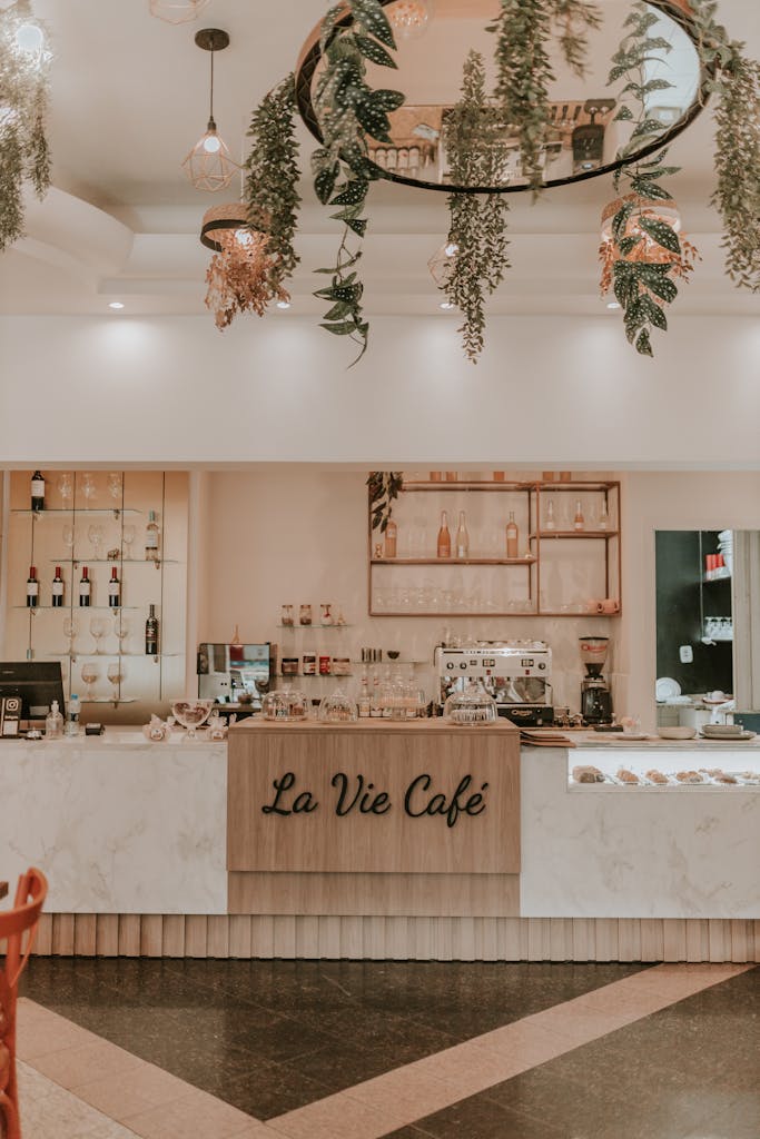 Chic interior of La Vie Café featuring modern design, hanging plants, and inviting atmosphere.